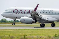 This photograph taken on June 7, 2023, shows an Qatar Airways Airbus A320 aircraft landing at the newly opened runway of Belgrade Nikola Tesla airport. The opening of Belgrade airport's new runway marked the completion of one of the major infrastructure projects undertaken by French operator Vinci, since taking over the concession in late 2018. (Photo by Andrej ISAKOVIC / AFP) (Photo by ANDREJ ISAKOVIC/AFP via Getty Images)