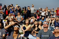 FILE PHOTO: People watch the solar eclipse on the lawn of Griffith Observatory in Los Angeles, California, U.S., August 21, 2017. Location coordinates for this image are 34?7'9"N 118?18'1"W.  REUTERS/Mario Anzuoni/File Photo