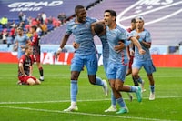 New York City FC's Julian Fernandez, foreground with head down, is congratulated by teammates Andrés Perea (15) and Andres Jasson (21) after his goal against Toronto FC during an MLS soccer match at Red Bull Arena, Sunday, Sept. 24, 2023, in Harrison, N.J. (AP Photo/Andres Kudacki)