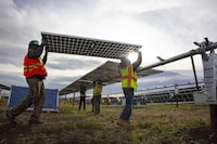 Workers put up solar panels at the construction site of the Canada’s biggest solar farm Travers Solar, near Vulcan, Alberta, November 9, 2021. Todd Korol/The Globe and Mail