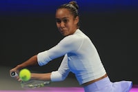 Canada's Leylah Fernandez returns to Kazakstan's Elena Rybakina during the Qatar Open quarter-final in Doha, Qatar, on Thursday, Feb. 15, 2024. Fernandez is out of the Dubai Tennis Championship after losing 6-3, 6-4 to Italy's Jasmine Paolini in the second round Tuesday. THE CANADIAN PRESS/AP/Hussein Sayed