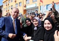 Turkish President Tayyip Erdogan poses with his supporters as he leaves a polling station during the local elections in Istanbul, Turkey March 31, 2024. Murat Kulu/PPO/Handout via REUTERS THIS IMAGE HAS BEEN SUPPLIED BY A THIRD PARTY. NO RESALES. NO ARCHIVES