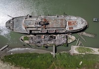 The retired BC Ferries vessel Queen of Sidney, top, that was in operation from 1960 to 2000, and another derelict vessel are seen moored on the Fraser River, in Mission, B.C., on Tuesday, July 18, 2023. THE CANADIAN PRESS/Darryl Dyck
