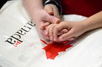 A mother and daughter hold hands during citizenship ceremony in Ottawa on Wednesday, April 17, 2019. Statistics Canada says the country welcomed more than 145,000 immigrants during the first the months of the year. THE CANADIAN PRESS/Sean Kilpatrick
