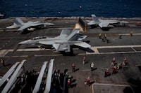 FILE PHOTO: U.S. navy F-18 Super Hornet and crews are seen on the flight deck on the USS Nimitz, off the coast of Busan, South Korea, 27 March 2023. The ROK-US combined maritime exercise is a part of Warrior Shield. Jeon Heon-Kyun/Pool via REUTERS