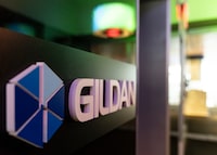 The Gildan logo is seen outside their offices in Montreal, Monday, Dec. 11, 2023.  Another long-time investor in Gildan Activewear Inc. says it does not trust the company's current board to oversee a sale process and called on it to hold its annual meeting without delay to allow shareholders to elect new directors. THE CANADIAN PRESS/Christinne Muschi