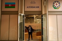 A person walks out of the Azerbaijan Pavilion at the COP28 U.N. Climate Summit, Friday, Dec. 8, 2023, in Dubai, United Arab Emirates. (AP Photo/Rafiq Maqbool)