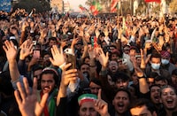 Supporters of former Prime Minister Imran Khan's party, the Pakistan Tehreek-e-Insaf (PTI), raise their hands as they shout slogans during a protest demanding free and fair results of the election, in Peshawar, Pakistan, February 10, 2024. REUTERS/Fayaz Aziz