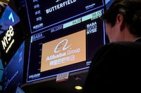 Trader works at the post where Alibaba is traded on the floor of the New York Stock Exchange (NYSE) in New York City, U.S., March 28, 2023.
