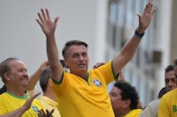 Former Brazilian President Jair Bolsonaro greets supporters during a rally in Sao Paulo, Brazil, on February 25, 2024, to reject claims he plotted a coup with allies to remain in power after his failed 2022 reelection bid. Investigators say the far-right ex-army captain led a plot to falsely discredit the Brazilian election system and prevent the winner of the vote, leftist President Luiz Inacio Lula da Silva, from taking power. A week after Lula took office on January 1, 2023, thousands of Bolsonaro supporters stormed the presidential palace, Congress and Supreme Court, urging the military to intervene to overturn what they called a stolen election. (Photo by NELSON ALMEIDA / AFP) (Photo by NELSON ALMEIDA/AFP via Getty Images)