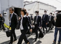 Japanese health ministry officials head to search a Kobayashi Pharmaceutical Co. factory in Osaka, Japan March 30, 2024, in this photo taken by Kyodo. Mandatory credit Kyodo/via REUTERS ATTENTION EDITORS - THIS IMAGE HAS BEEN SUPPLIED BY A THIRD PARTY. MANDATORY CREDIT. JAPAN OUT. NO COMMERCIAL OR EDITORIAL SALES IN JAPAN.