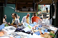 FILE PHOTO: People shop at Borough Market in London, Britain July 19, 2023. REUTERS/Anna Gordon/File Photo