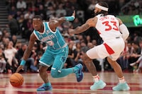 Charlotte Hornets guard Terry Rozier (3) tries to fend off Toronto Raptors guard Gary Trent Jr. (33) during first half NBA basketball action in Toronto, Monday, Dec. 18, 2023. THE CANADIAN PRESS/Nathan Denette