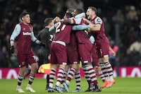 West Ham players celebrate at the end of the English Premier League soccer match between Tottenham Hotspur and West Ham United at the Tottenham Hotspur Stadium in London, England, Thursday, Dec. 7, 2023. West Ham won 2-1. (AP Photo/Kin Cheung)