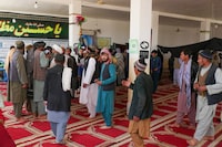 Afghans gather at a mosque where gunmen attacked Shiite Muslims in Guzara district of Herat province on April 30, 2024. A gunman stormed a mosque in western Afghanistan and killed six people, a government spokesman said April 30, with local residents claiming the minority Shiite community had been targeted. (Photo by Mohsen KARIMI / AFP) (Photo by MOHSEN KARIMI/AFP via Getty Images)