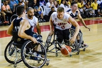 Canada team player Patrick Anderson (C-2) controls the ball between US team players Ian Lynch (L) and Steve Serio during their IWBF Men's American Cup of Wheelchair Basketball final on August 30, 2017, in Cali, Colombia.
The United States team won the tournament, Canada team was second and Argentina team was third. / AFP PHOTO / LUIS ROBAYO        (Photo credit should read LUIS ROBAYO/AFP via Getty Images)