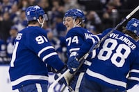 Toronto Maple Leafs teammates John Tavares (91), Bobby McMann (74) and William Nylander (88) celebrate a goal against the Edmonton Oilers during second period NHL hockey in Toronto, Saturday, March 23, 2024. THE CANADIAN PRESS/Nick Iwanyshyn