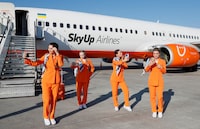 FILE PHOTO: Flight attendants of SkyUp Airlines pose for a picture on a tarmac during the presentation of a new uniform at the Boryspil International Airport outside Kyiv, Ukraine September 30, 2021. REUTERS/Gleb Garanich/File Photo