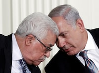FILE PHOTO: Israeli Prime Minister Benjamin Netanyahu (R) and Palestinian President Mahmoud Abbas speak during an event about the Middle East peace talks in the East Room at the White House in Washington, U.S., September 1, 2010. REUTERS/Jim Young/File Photo