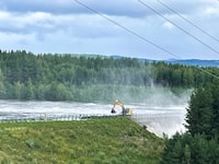 Workers reinforce a dam that at risk of bursting, after the water level rose due to stormy weather, in Brasfereidfoss, Norway, Wednesday Aug. 9, 2023. Authorities in Norway are considering blowing up a dam at risk of bursting after days of heavy rain to prevent downstream communities from getting deluged. The Glama, Norway’s longest and most voluminous river, is dammed at the the Braskereidfoss hydroelectric power plant, which was under water and out of operation on Wednesday. (Bard Langvandslien/NTB Scanpix via AP)