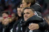 Toronto FC's incoming head coach John Herdman is embraced as they sing the national anthem prior to first half MLS soccer action against the Orlando City, in Toronto on Saturday, Oct. 21, 2023. THE CANADIAN PRESS/Nathan Denette