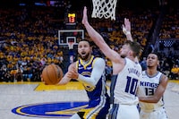 Golden State Warriors guard Stephen Curry, left, shoots while defended by Sacramento Kings center Domantas Sabonis (10) during the first half of Game 6 of a first-round NBA basketball playoff series in San Francisco, Friday, April 28, 2023. (AP Photo/Godofredo A. Vásquez)