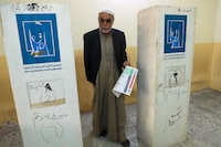 An elderly Iraqi man casts his vote in the country's provincial elections in Basra, Iraq, Monday, Dec. 18, 2023. (AP Photo/Nabil al-Jurani)