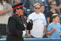 Sgt. Chantal Larocque sings "O Canada'" in English, French and Algonquin at Rogers Centre before American League MLB baseball action against Tampa Bay Rays in Toronto, Saturday, Sept. 30, 2023. Larocque, who is an officer with the Anishinabek Police Service, sang the national anthem on Saturday as part of the Major League Baseball team's ceremony for National Truth and Reconciliation Day.  THE CANADIAN PRESS/Frank Gunn

