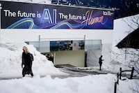 A huge advertising banner with a slogan about AI is fixed at a building at the Davos Promenade, alongside the World Economic Forum in Davos, Switzerland, Thursday, Jan. 18, 2024. The AI technology has taken a large and growing slice of attention in Davos, this year the theme of Artificial Intelligence "as a driving force for the economy and society" will get about 30 separate sessions. (AP Photo/Markus Schreiber)