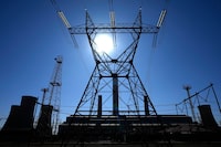The sun shines over Komati Power Station in Middelburg, South Africa, Monday, June 19, 2023. The coal-fired plant was shut down to make way for a solar, wind and battery storage plant. (AP Photo/Themba Hadebe)