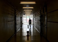 FILE PHOTO: A teacher walks the divided hallways at Hunter's Glen Junior Public School, part of the Toronto District School Board (TDSB), in Scarborough, Ontario, Canada September 14, 2020. Picture taken September 14, 2020.   Nathan Denette/Pool via REUTERS/File Photo