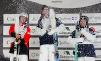 Canada's Elliot Vaillancourt, left, celebrates silver alongside  Swedens's Filip Gravenfors, right, who took bronze and Walter Wallberg, centre, who captured gold in the men's freestyle ski world cup moguls at Val Saint-Come, Que., on Friday, Jan. 19, 2024. THE CANADIAN PRESS/Sean Kilpatrick
