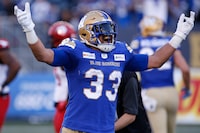 Winnipeg Blue Bombers' Andrew Harris (33) celebrates his touchdown against the Calgary Stampeders during first half CFL football action in Winnipeg, Sunday, Aug. 29, 2021. 
Harris will finish his illustrious CFL career with his hometown team. Harris, 37, will sign a one-day contract Saturday to retire as a member of the Winnipeg Blue Bombers, the CFL team announced Friday. THE CANADIAN PRESS/John Woods
