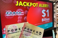 Powerball tickets are shown in front of a screen displaying the estimated jackpot, Wednesday, April 3, 2024, in Surfside, Fla. An estimated $1.09 billion Powerball jackpot that ranks as the 9th largest in U.S. lottery history will be up for grabs Wednesday night, April 3. (AP Photo/Wilfredo Lee)