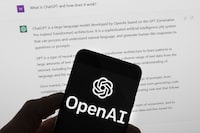 FILE - The OpenAI logo is seen on a mobile phone in front of a computer screen which displays output from ChatGPT, March 21, 2023, in Boston. A wave of AI deepfakes tied to elections in Europe and Asia has coursed through social media for months, serving as a warning for more than 50 countries heading to the polls this year. (AP Photo/Michael Dwyer, File)