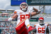 Kansas City Chiefs tight end Travis Kelce (87) celebrates his touchdown by kicking a ball into the stands during an NFL football game against the Jacksonville Jaguars, Sunday, Sept. 17, 2023, in Jacksonville, Fla. The Chiefs defeated the Jaguars 17-9. (AP Photo/Gary McCullough)