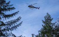 An RCMP helicopter is seen patrolling the Fairy Creek logging area near Port Renfrew, B.C., on Monday, Oct. 4, 2021. Mounties are back enforcing an injunction on Vancouver Island less than a week after the Supreme Court of Canada confirmed the acquittal of a protester at the same site because police failed to fully read out the court's order. THE CANADIAN PRESS/Jonathan Hayward
