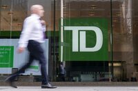 The $15.9 million settlement of a class-action lawsuit related to TD Bank Group's insufficient fund fees has been approved by an Ontario Superior Court. A person makes their way past a Toronto-Dominion Bank branch in Toronto, Monday, Aug. 14, 2023. THE CANADIAN PRESS/Spencer Colby