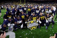 HOUSTON, TEXAS - JANUARY 08: Drake Nugent #60 of the Michigan Wolverines poses with teammates after defeating the Washington Huskies during the 2024 CFP National Championship game at NRG Stadium on January 08, 2024 in Houston, Texas. Michigan defeated Washington 34-13. (Photo by Stacy Revere/Getty Images)