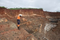 GOROMONZI, ZIMBABWE - JANUARY 11: A worker inspects an open cast at Arcadia Lithium mine on January 11, 2022 in Goromonzi, Zimbabwe. Last month, the Chinese firm Zhejiang Huayou Cobalt said it would pay over $400 million for the hard-rock lithium mine, whose product is a key ingredient in rechargeable batteries used in electric vehicles. The world's transition to "clean energy" may strain global mining capacity to produces these minerals.  (Photo by Tafadzwa Ufumeli/Getty Images)