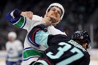 SEATTLE, WASHINGTON - NOVEMBER 24: Teddy Blueger #53 of the Vancouver Canucks fights Yanni Gourde #37 of the Seattle Kraken during the third period at Climate Pledge Arena on November 24, 2023 in Seattle, Washington. (Photo by Steph Chambers/Getty Images)