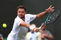 LONDON, ENGLAND - JULY 06: Stan Wawrinka of Switzerland plays a backhand against Tomas Martin Etcheverry of Argentina during day four of The Championships Wimbledon 2023 at All England Lawn Tennis and Croquet Club on July 06, 2023 in London, England. (Photo by Clive Brunskill/Getty Images)