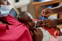 FILE PHOTO: A nurse administers the malaria vaccine to an infant at the Lumumba Sub-County hospital in Kisumu, Kenya, July 1, 2022. REUTERS/Baz Ratner/File Photo