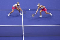and Gabriela Dabrowski, of Canada, right, returns a shot alongside doubles partner Erin Routliffe, of New Zealand, left, during the women's doubles final of the U.S. Open tennis championships against Laura Siegemund, of Germany, and Vera Zvonareva, of Russia, Sunday, Sept. 10, 2023, in New York. (AP Photo/Manu Fernandez)