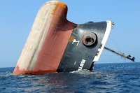This picture taken on March 7, 2024 shows the Rubymar cargo ship partly submerged off the coast of Yemen. The bulk carrier went down off Yemen after a Huthi missile attack and poses grave environmental risks as thousands of tonnes of fertiliser threaten to spill into the Red Sea, officials and experts warn. The Belize-flagged, Lebanese-operated Rubymar sank on Saturday with 21,000 metric tonnes of ammonium phosphate sulfate fertiliser on board, according to US Central Command. (Photo by Khaled Ziad / AFP) (Photo by KHALED ZIAD/AFP via Getty Images)