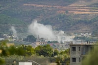 Smoke rises after a shelling in Um el-Tot, a Lebanese border village with Israel, south Lebanon, Thursday, Oct. 19, 2023. The Qassam Brigades, the military wing of Hamas, said in a statement that its members fired 30 rockets from south Lebanon into northern Israel Thursday mainly targeting the towns of Nahariya and Shlomi. (AP Photo/Hassan Ammar)