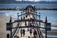 People walk on the pier in White Rock, B.C., on Sunday, June 28, 2020. THE CANADIAN PRESS/Darryl Dyck