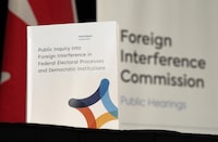 A copy of the interim report is seen on a table following its release at the Public Inquiry Into Foreign Interference in Federal Electoral Processes and Democratic Institutions, in Ottawa, Friday, May 3, 2024. THE CANADIAN PRESS/Adrian Wyld