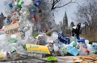 A person walks past a public art installation outside a United Nations conference on plastics on Tuesday, April 23, 2024 in Ottawa.  THE CANADIAN PRESS/Adrian Wyld