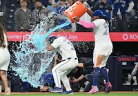 Apr 8, 2024; Toronto, Ontario, CAN;  Toronto Blue Jays first baseman Vladimir Guerrero Jr. (27) pours sports drink over left fielder Davis Schneider (36) as they celebrate winning the Jays home opener over the Seattle Mariners at Rogers Centre. Mandatory Credit: Dan Hamilton-USA TODAY Sport